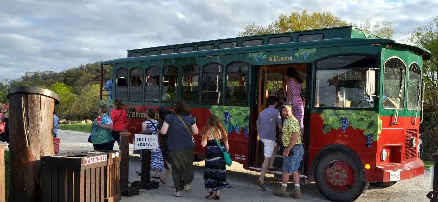 A group of people getting on to a bus.