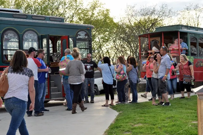 A group of people standing around a trolley.